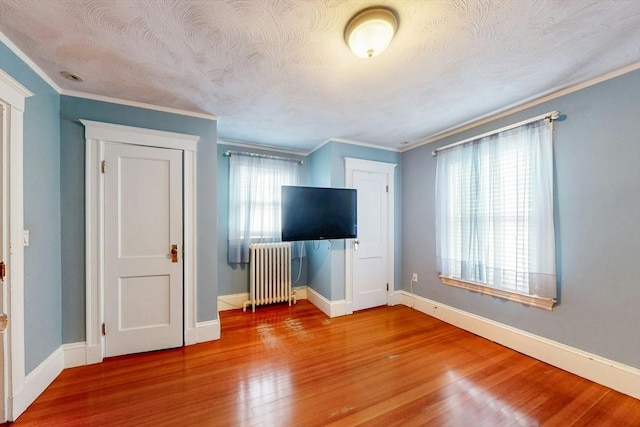 19 Orlando Ave, Winthrop, MA 02152 - unfurnished bedroom featuring radiator heating unit, wood finished floors, baseboards, and ornamental molding