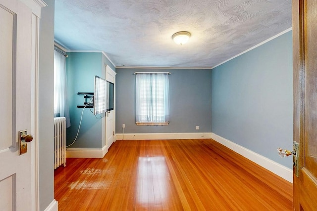 19 Orlando Ave, Winthrop, MA 02152 - unfurnished room featuring radiator heating unit, wood finished floors, baseboards, crown molding, and a textured ceiling