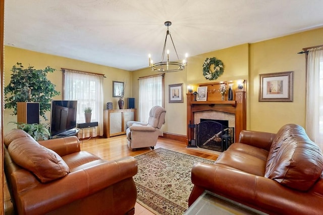 19 Orlando Ave, Winthrop, MA 02152 - living room featuring a chandelier, light wood finished floors, and a tiled fireplace