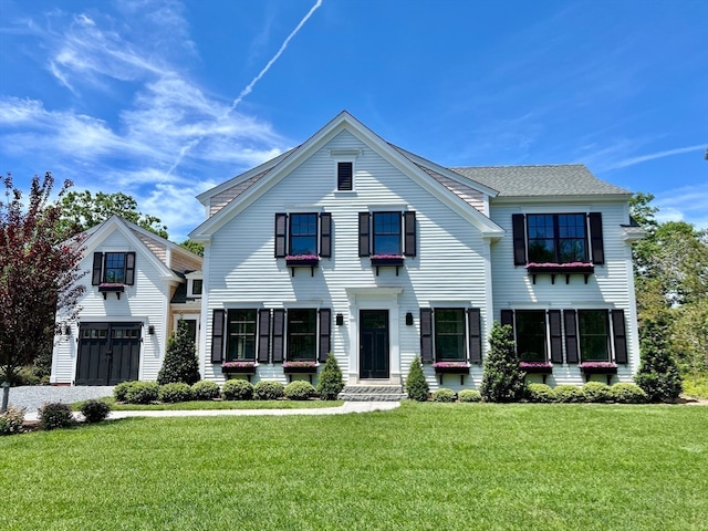 view of front of home featuring a garage and a front yard