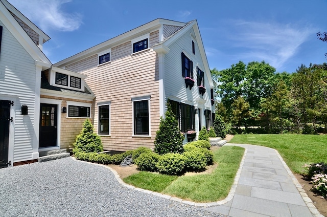 view of property exterior featuring a lawn