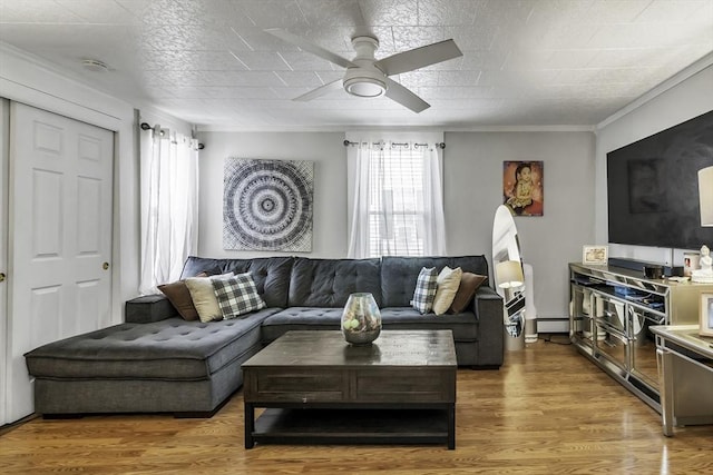 87 Lilley Ave, Lowell, MA 01850 - living area featuring a ceiling fan, a baseboard heating unit, wood finished floors, and crown molding