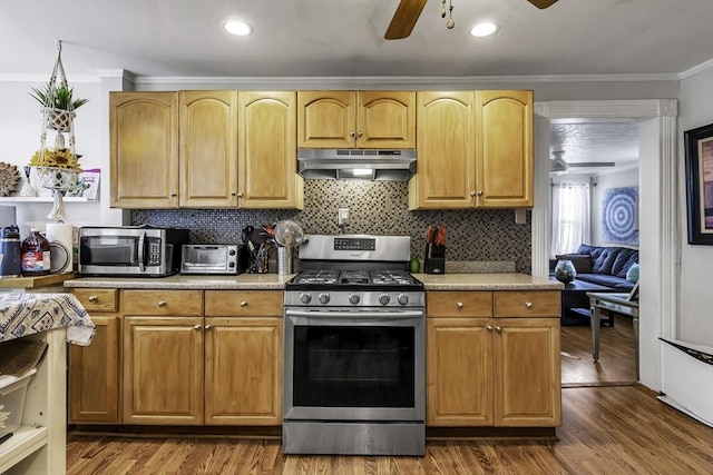 87 Lilley Ave, Lowell, MA 01850 - kitchen featuring appliances with stainless steel finishes, under cabinet range hood, ceiling fan, ornamental molding, and dark wood-type flooring