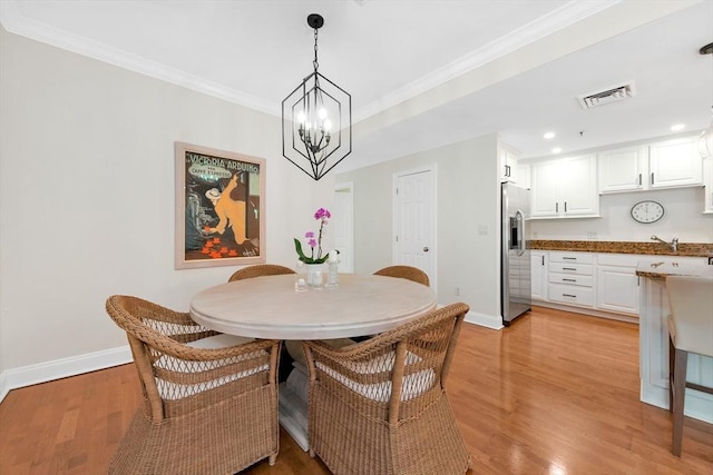 95 Conant St Unit 404, Concord, MA 01742 - dining room with baseboards, light wood-style floors, crown molding, a chandelier, and recessed lighting