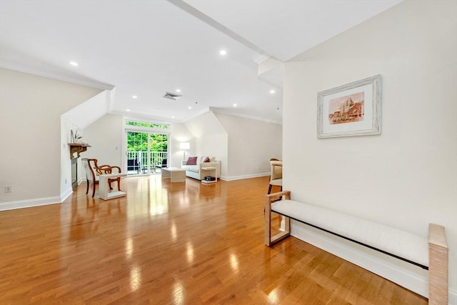 95 Conant St Unit 404, Concord, MA 01742 - living area with light wood finished floors, crown molding, recessed lighting, and baseboards