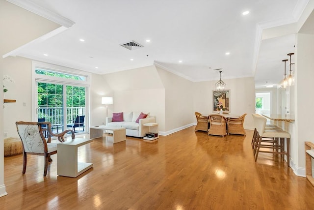 95 Conant St Unit 404, Concord, MA 01742 - living area featuring light wood-type flooring, ornamental molding, baseboards, recessed lighting, and a chandelier
