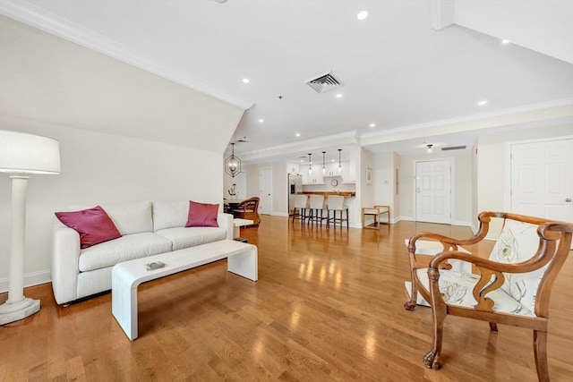 95 Conant St Unit 404, Concord, MA 01742 - living room with ornamental molding, recessed lighting, baseboards, light wood-style floors, and vaulted ceiling