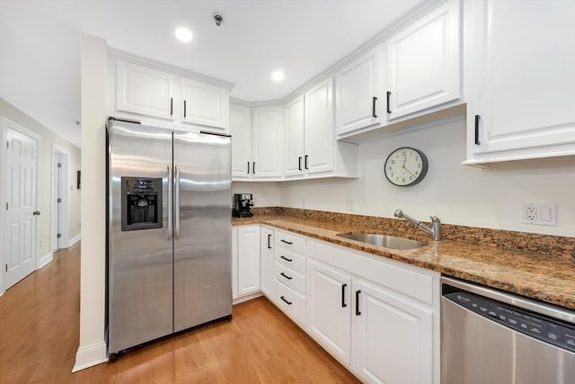95 Conant St Unit 404, Concord, MA 01742 - kitchen featuring stainless steel appliances, a sink, light wood finished floors, white cabinets, and recessed lighting