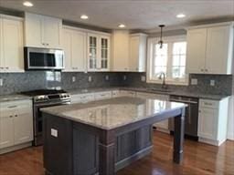 41 Rustic Dr, Worcester, MA 01609 - kitchen featuring stainless steel appliances, white cabinets, a kitchen island, pendant lighting, and recessed lighting