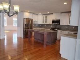 41 Rustic Dr, Worcester, MA 01609 - kitchen featuring appliances with stainless steel finishes, a chandelier, backsplash, recessed lighting, and white cabinetry