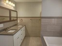 41 Rustic Dr, Worcester, MA 01609 - bathroom with tile walls, a tub, double vanity, and wainscoting