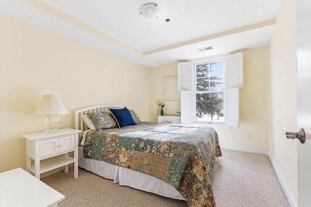 bedroom featuring light colored carpet and baseboards