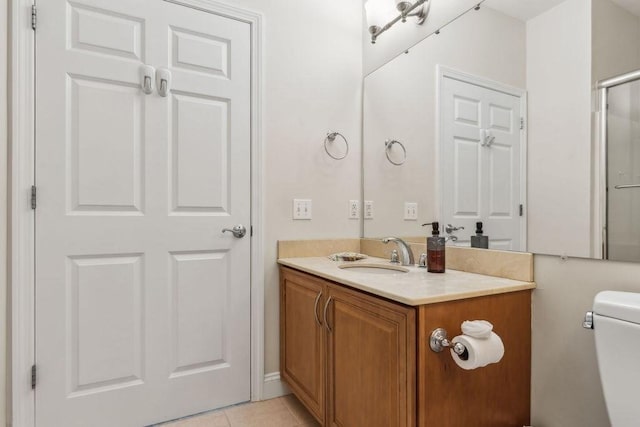 bathroom with vanity, toilet, and tile patterned floors