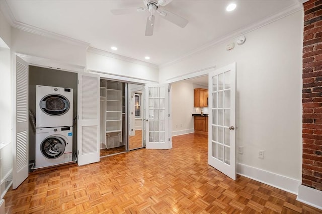 laundry room with stacked washing machine and dryer, french doors, baseboards, ceiling fan, and ornamental molding