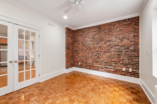 empty room with brick wall, baseboards, french doors, crown molding, and a ceiling fan