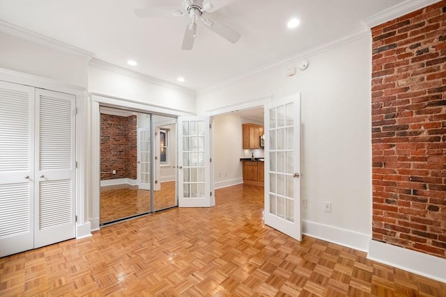 unfurnished bedroom featuring french doors, two closets, baseboards, brick wall, and ornamental molding