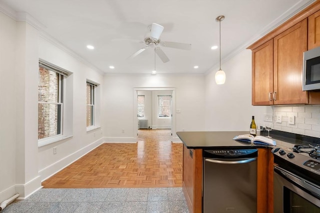 kitchen featuring stainless steel appliances, dark countertops, brown cabinetry, baseboards, and crown molding