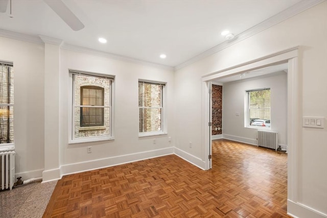 spare room featuring radiator heating unit, ceiling fan, baseboards, ornamental molding, and recessed lighting