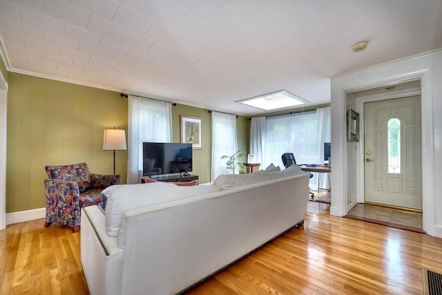 108 Needham St, Dedham, MA 02026 - living area featuring ornamental molding, plenty of natural light, light wood-type flooring, and baseboards