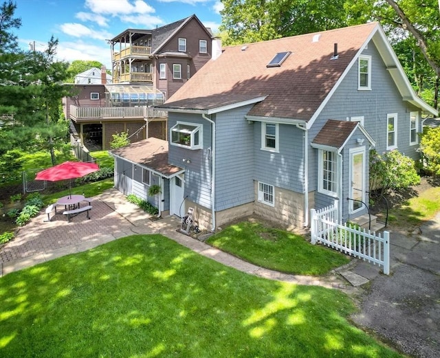 108 Needham St, Dedham, MA 02026 - back of property with a shingled roof, a yard, and a patio