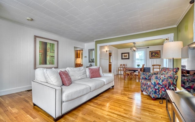 108 Needham St, Dedham, MA 02026 - living area with ornamental molding, light wood-style floors, and a chandelier