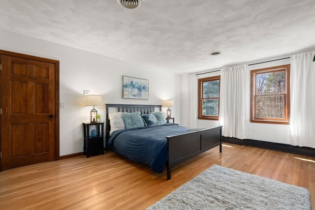 5 Crescent Ln, Sudbury, MA 01776 - bedroom with light wood-style flooring, baseboards, and visible vents