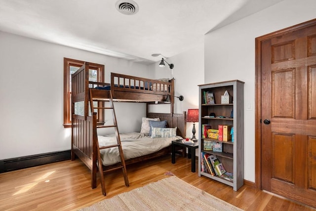 5 Crescent Ln, Sudbury, MA 01776 - bedroom featuring light wood-style floors, a baseboard heating unit, baseboards, and visible vents