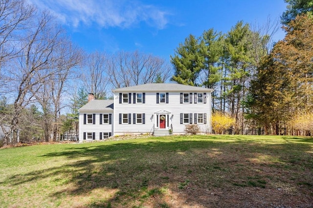 5 Crescent Ln, Sudbury, MA 01776 - colonial house featuring entry steps, a front lawn, and a chimney