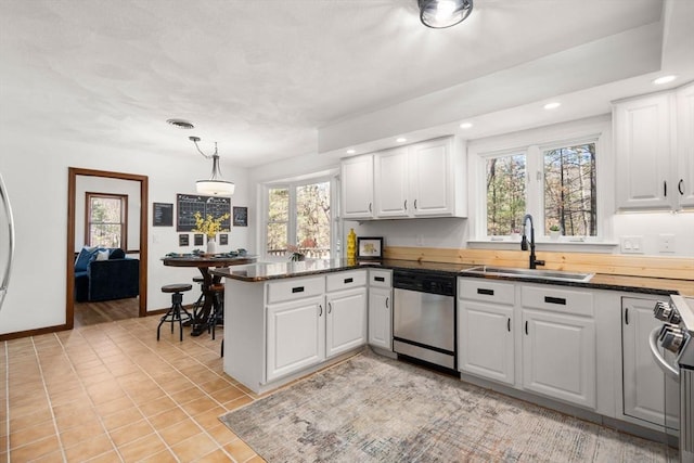 5 Crescent Ln, Sudbury, MA 01776 - kitchen featuring stainless steel dishwasher, a peninsula, recessed lighting, a healthy amount of sunlight, and a sink