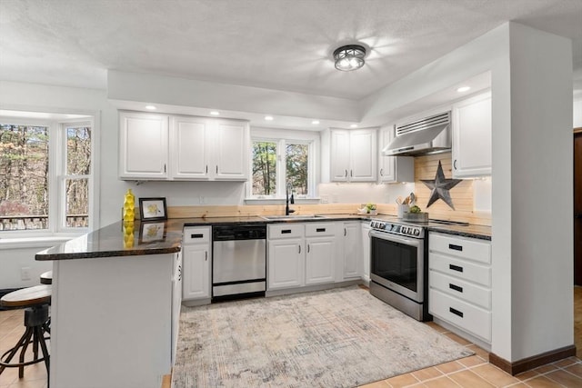 5 Crescent Ln, Sudbury, MA 01776 - kitchen with a kitchen breakfast bar, a peninsula, wall chimney range hood, appliances with stainless steel finishes, and a sink