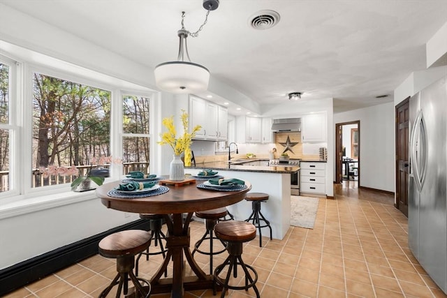 5 Crescent Ln, Sudbury, MA 01776 - kitchen with range hood, a peninsula, visible vents, a sink, and stainless steel appliances