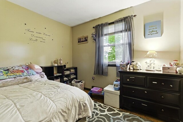 bedroom with wood finished floors and baseboards