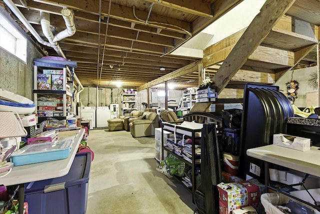 below grade area with washing machine and dryer and electric water heater