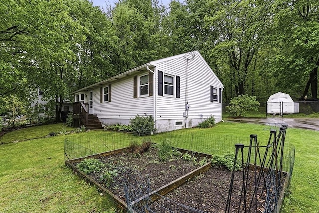 view of property exterior featuring a garden, a yard, and an outdoor structure