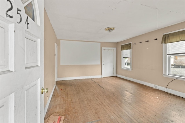 empty room with light hardwood / wood-style flooring