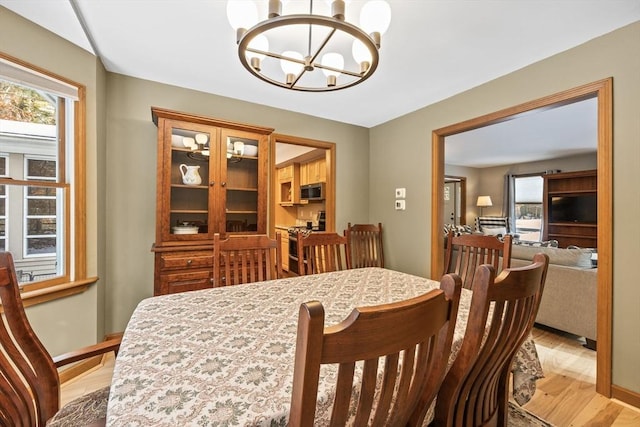 dining area featuring an inviting chandelier and light wood-type flooring