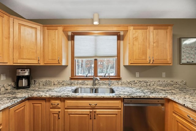 kitchen featuring sink, stainless steel dishwasher, and light stone countertops