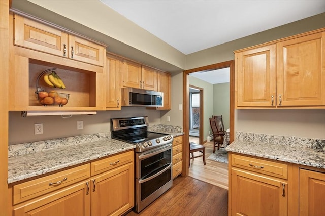 kitchen featuring stainless steel appliances, light stone countertops, dark wood-type flooring, and light brown cabinetry