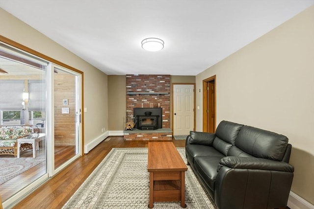 living room with dark hardwood / wood-style floors and a wood stove