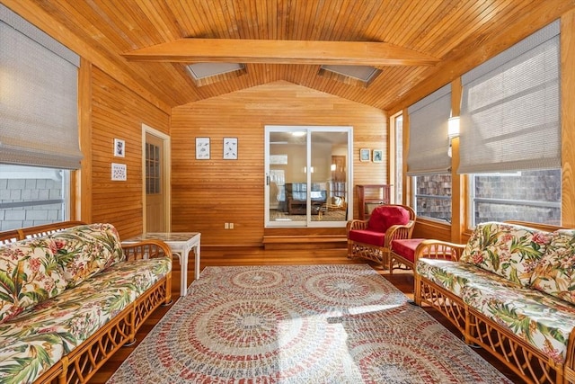 living room featuring lofted ceiling with beams, hardwood / wood-style floors, wood ceiling, and wood walls