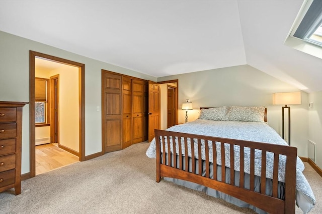 bedroom featuring vaulted ceiling and light colored carpet