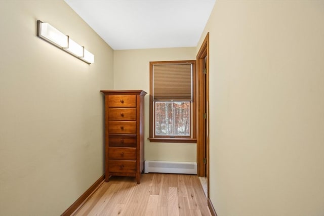 interior space with a baseboard radiator and light wood-type flooring