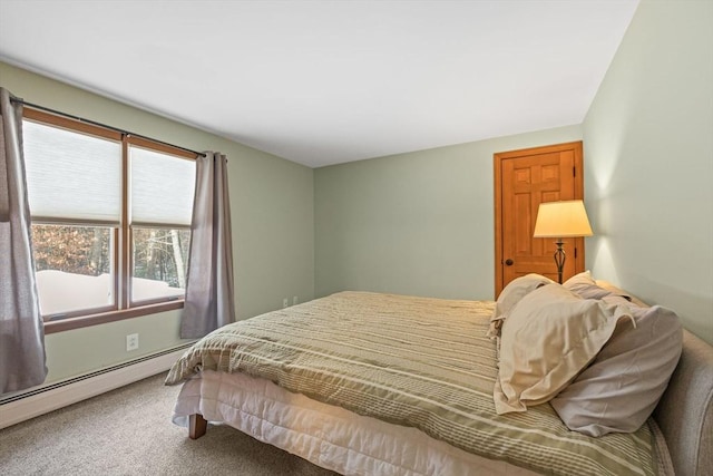 bedroom with a baseboard heating unit and carpet flooring