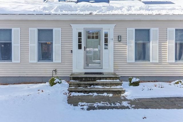 view of snow covered property entrance