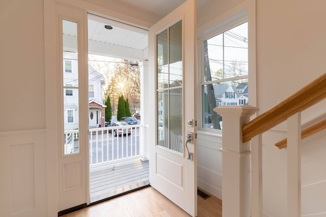 doorway featuring light wood-type flooring and a healthy amount of sunlight