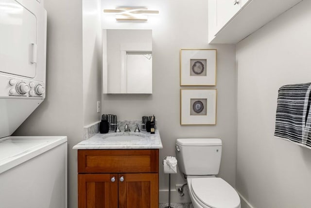 90 Broadway Unit 2C, Boston, MA 02116 - half bathroom featuring stacked washer and clothes dryer and vanity