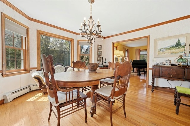 dining room with crown molding, light wood finished floors, a baseboard heating unit, and a chandelier