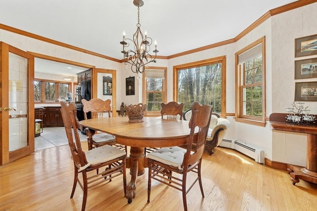 dining area with a chandelier, ornamental molding, baseboard heating, and light wood-type flooring