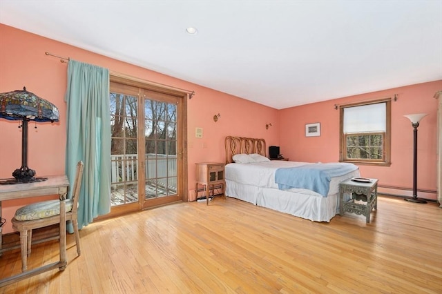 bedroom featuring recessed lighting, access to exterior, baseboard heating, and light wood-style floors