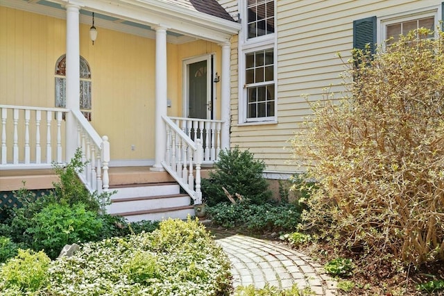 entrance to property featuring covered porch
